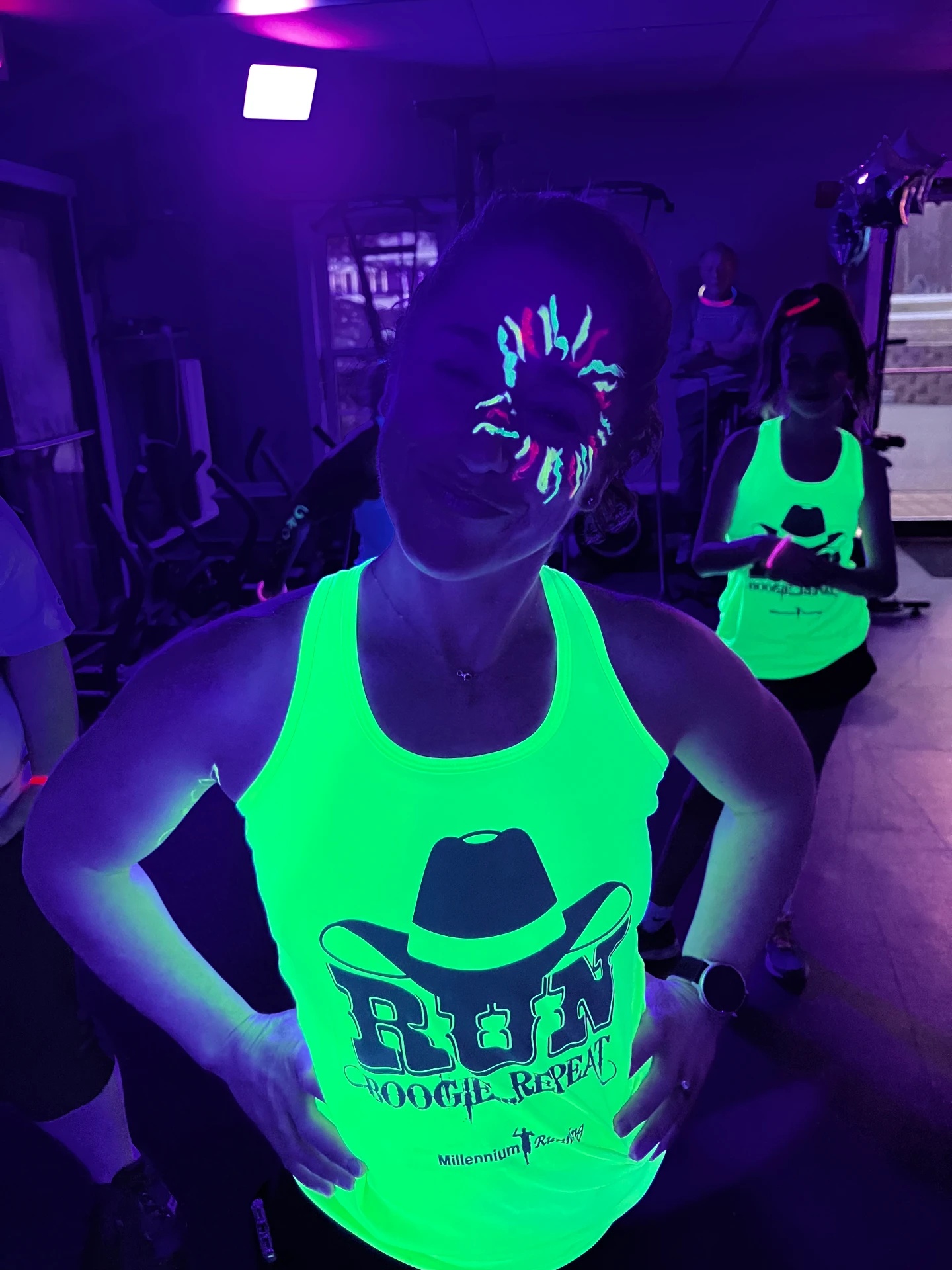 Glow-event guests wearing bright neon green workout tops